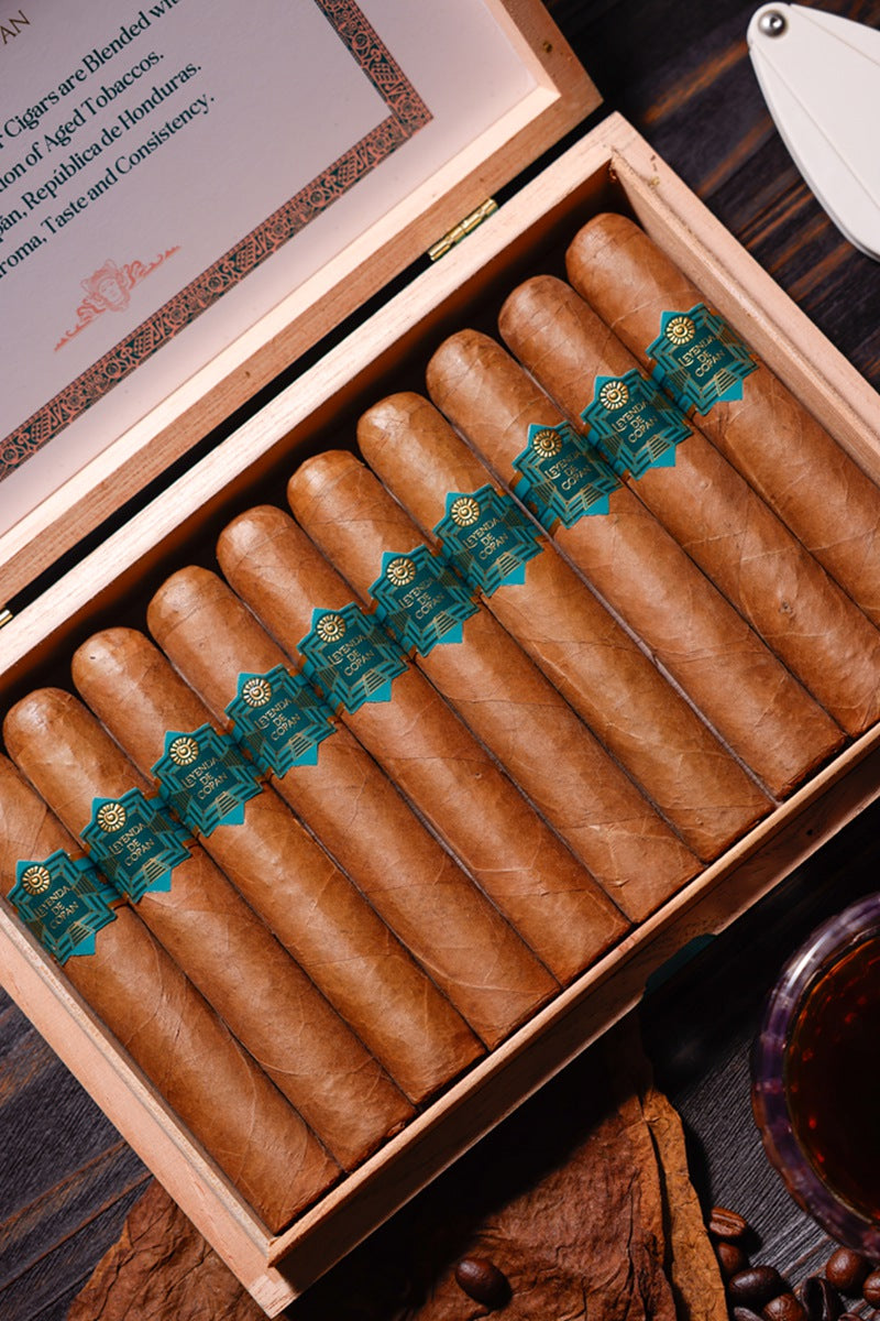 Box of cigars with green labels on a wooden surface